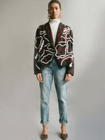 Fanfare Label sustainable women’s clothing brand UK. Our upcycled jeans are high-waisted, blue denim and made from recycled denim. We decorate every jean with a white embroidered thread in a face design.