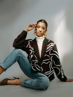 Fanfare Label sustainable women’s clothing brand UK. Our upcycled jeans are high-waisted, blue denim and made from recycled denim. We decorate every jean with a white embroidered thread in a face design.