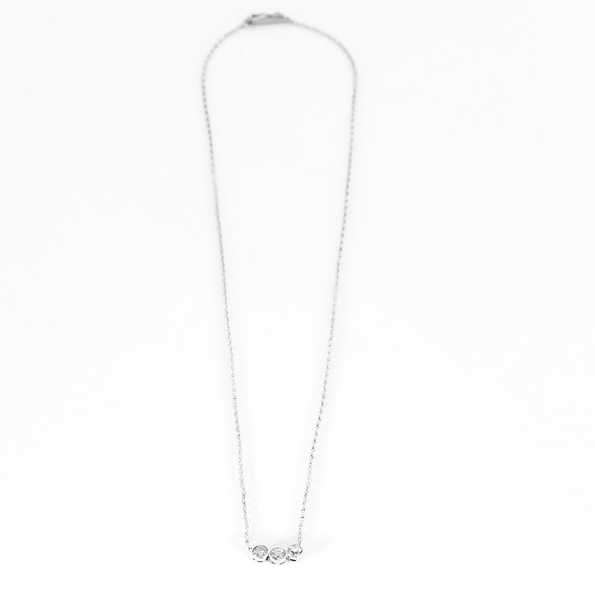 Collier en or gris, platine et trois diamants.