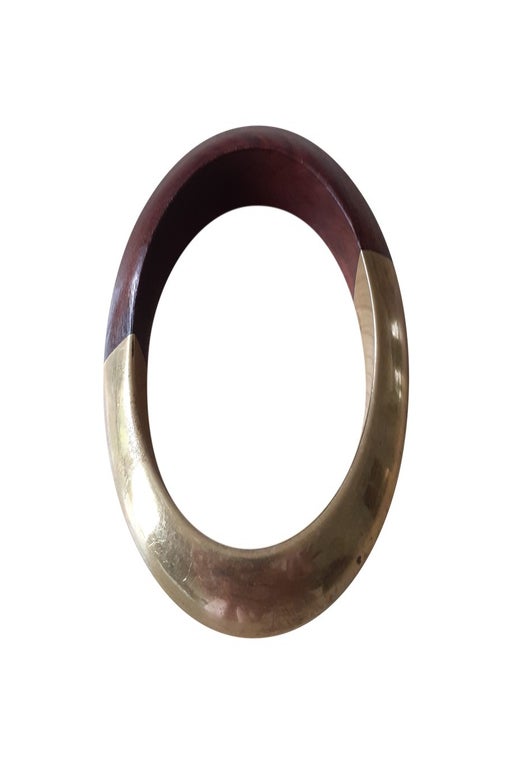 Bangle bracelet in wood and gold metal.