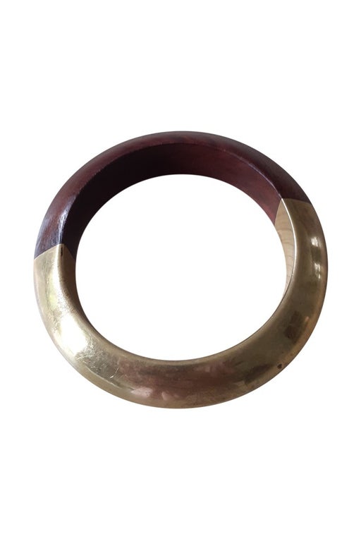 Bangle bracelet in wood and gold metal.