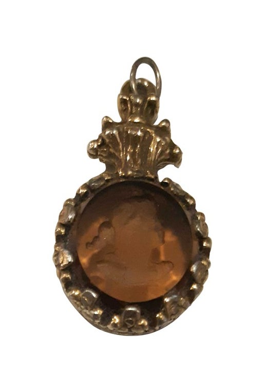Gold metal and engraved glass pendant