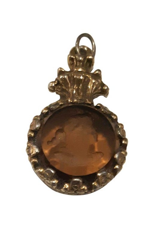 Gold metal and engraved glass pendant