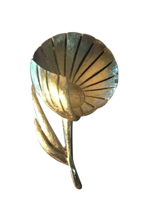 Golden metal flower brooch