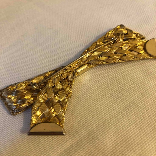 Golden metal brooch
