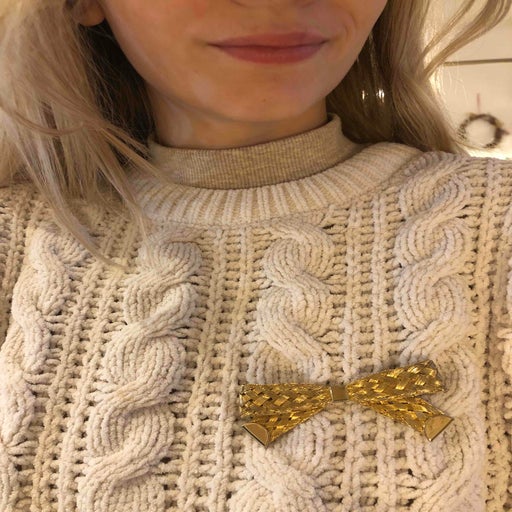 Golden metal brooch