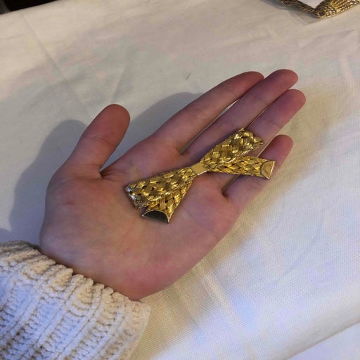 Golden metal brooch