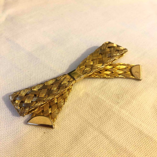 Golden metal brooch