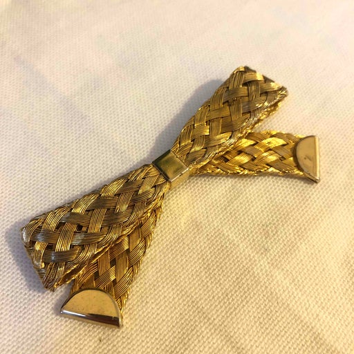 Golden metal brooch