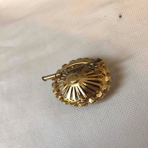 Golden metal brooch