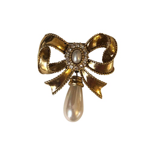 Golden metal brooch