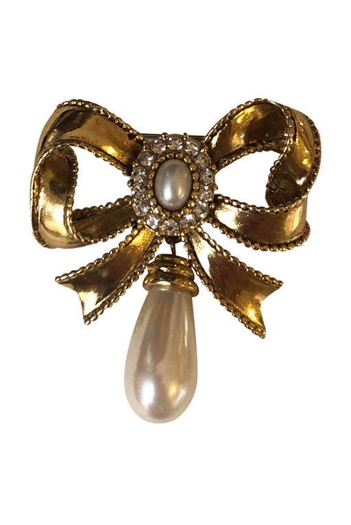 Golden metal brooch