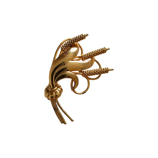 Golden metal brooch