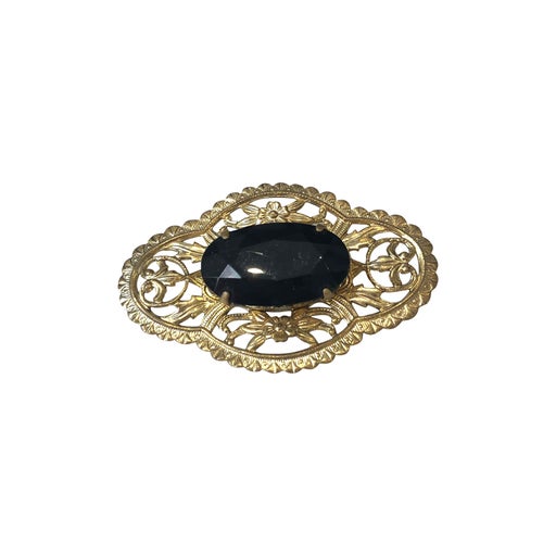 Golden metal brooch